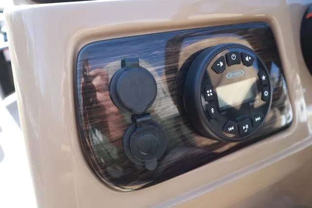 Slide: The Image of Dashboard controls of a 2020 Lowe SS 210 V boat, featuring audio system and power outlets. - 19