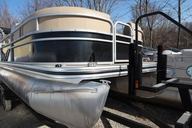Slide: The Image of 2020 Lowe SS 210 V pontoon boat on trailer, parked outdoors. - 20