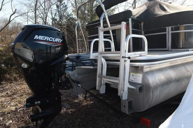 Slide: The Image of 2020 Lowe SS 210 V pontoon boat with Mercury outboard motor, parked outdoors. - 4