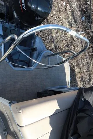 Slide: The Image of 2020 Lowe SS 210 V boat interior with seating and railing, featuring a Mercury engine. - 5