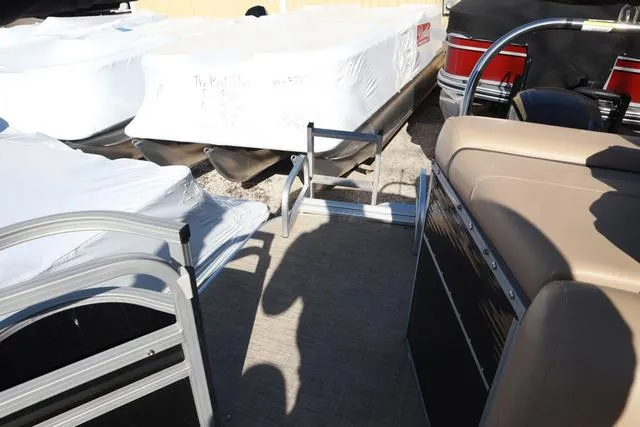 Slide: The Image of 2020 Lowe SS 210 V pontoon boat interior with beige seating and metal railings. - 6