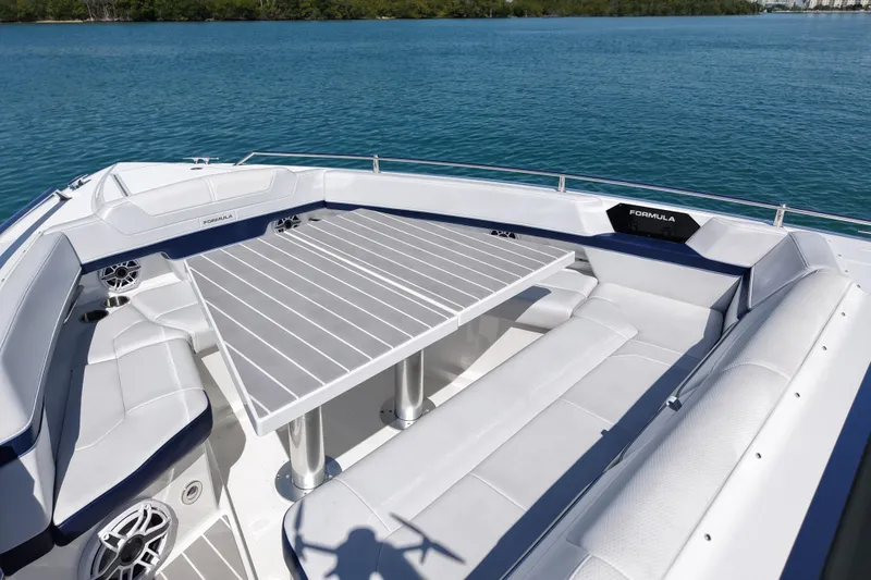 Slide: The Image of 2024 Formula 430 SSC boat with spacious seating and table on calm water. - 12