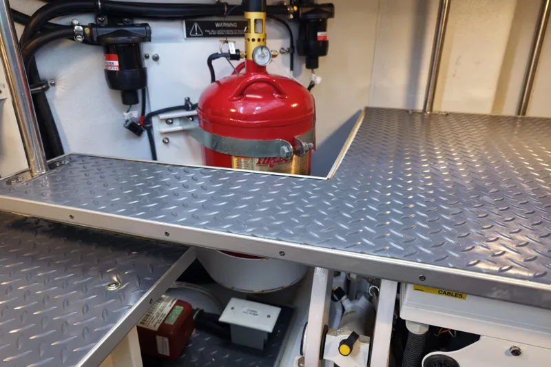 Slide: The Image of Engine compartment of 2024 Formula 430 SSC with diamond plate flooring and fire extinguisher. - 26