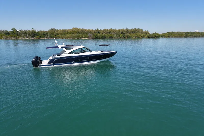 Slide: The Image of 2024 Formula 430 SSC cruising on a serene lake under a clear blue sky. - 3