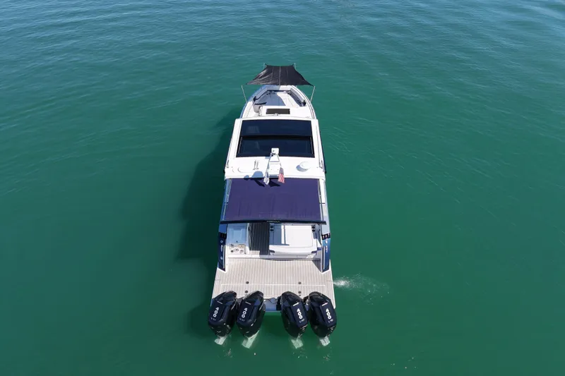 Slide: The Image of 2024 Formula 430 SSC luxury boat cruising on calm green waters. - 4