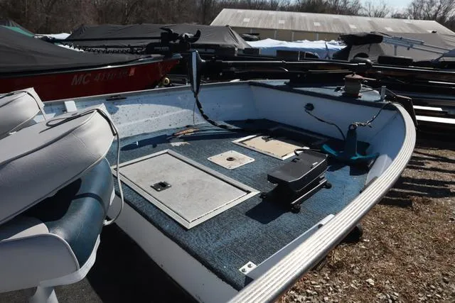 Slide: The Image of 1996 Grumman GV1465 boat deck with seating and storage compartments. - 3