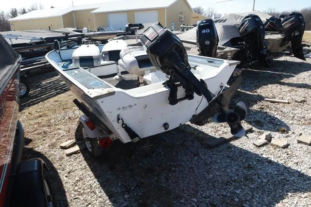 Slide: The Image of 1996 Grumman GV1465 boat with outboard motor, parked on gravel lot. - 4