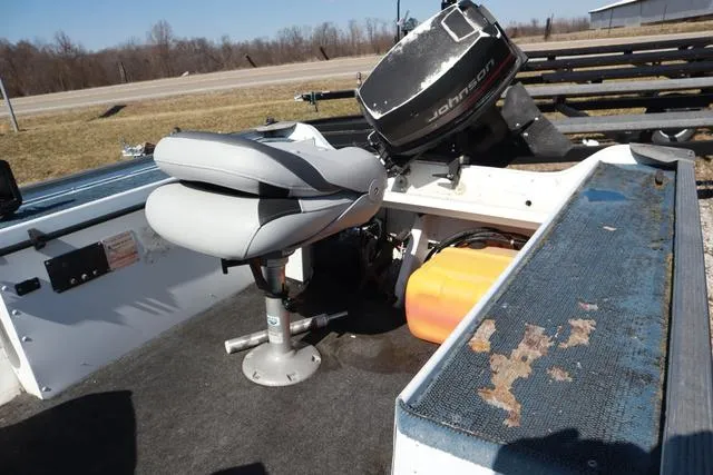 Slide: The Image of 1996 Grumman GV1465 boat interior with Johnson outboard motor and swivel seat. - 5