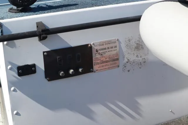 Slide: The Image of Control panel on a 1996 Grumman GV1465 boat with capacity label. - 6