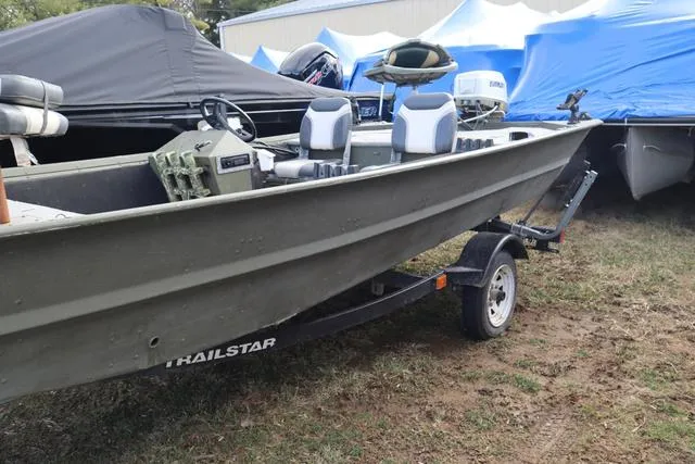 Slide: The Image of 1984 Monark 1648 SC boat on a Trailstar trailer, parked outdoors. - 14