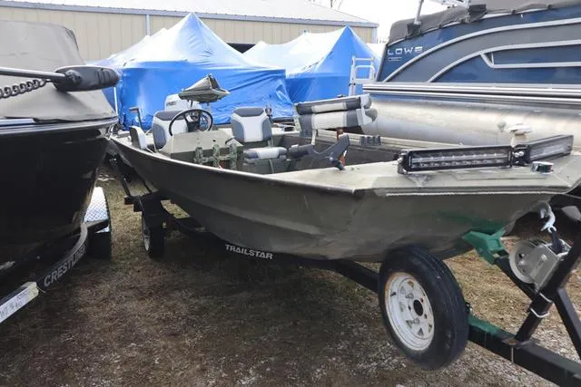Slide: The Image of 1984 Monark 1648 SC boat on trailer, parked outdoors among other boats. - 17