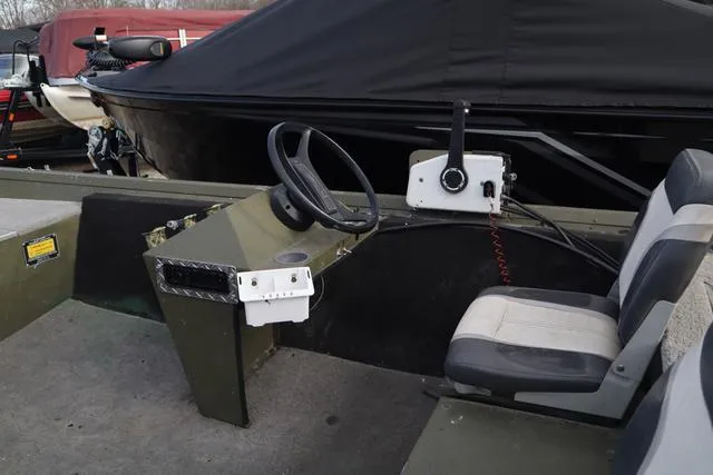 Slide: The Image of 1984 Monark 1648 SC boat interior with steering wheel and seating. - 5