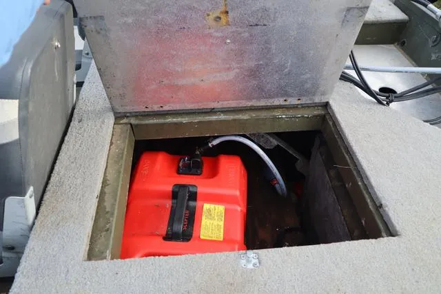 Slide: The Image of Open storage compartment in 1984 Monark 1648 SC boat with red fuel tank inside. - 7