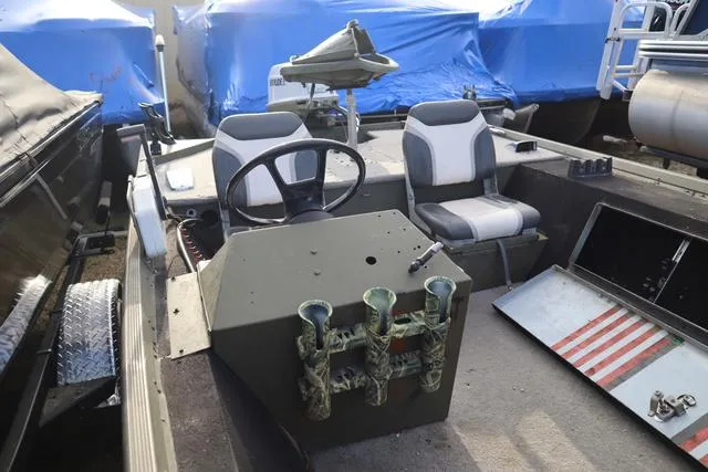 Slide: The Image of 1984 Monark 1648 SC boat interior with steering wheel and seating. - 9