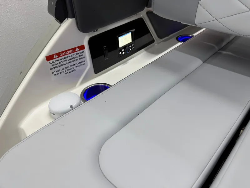 Slide: The Image of 2025 Chaparral 2870 SSX boat interior with seating, control panel, and cup holders. - 10