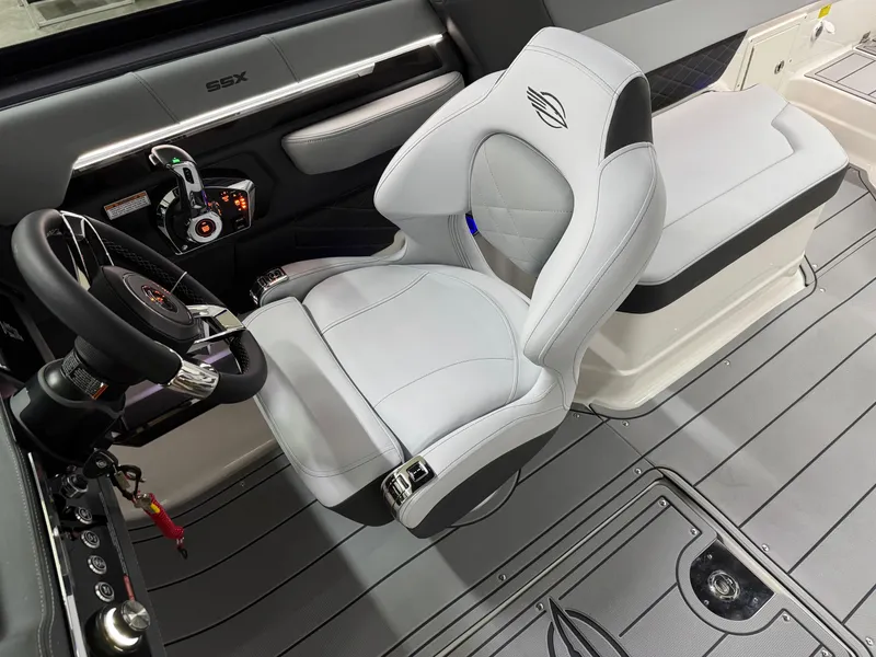 Slide: The Image of 2025 Chaparral 2870 SSX boat interior with sleek steering and modern seating. - 17