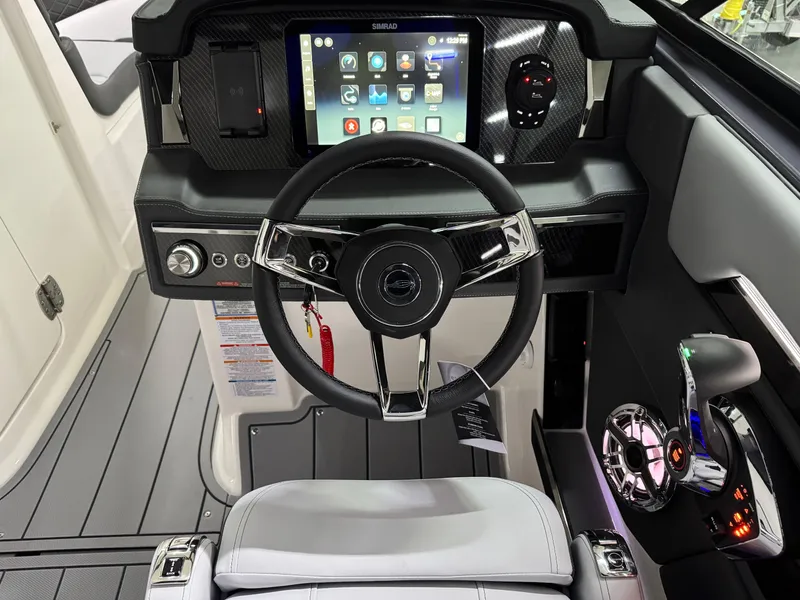 Slide: The Image of 2025 Chaparral 2870 SSX boat cockpit with modern steering wheel and digital dashboard display. - 20