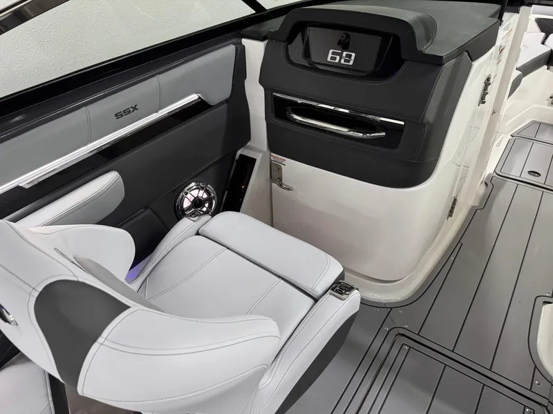 Slide: The Image of 2025 Chaparral 2870 SSX boat interior with modern dashboard and seating. - 22