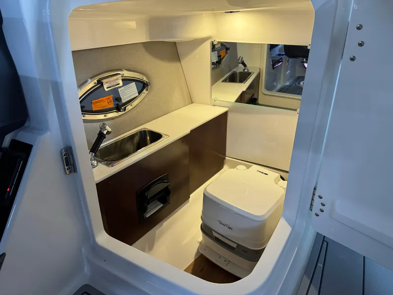 Slide: The Image of 2025 Chaparral 2870 SSX boat interior with sink and portable toilet. - 23