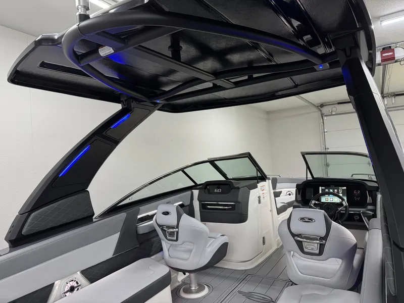 Slide: The Image of 2025 Chaparral 2870 SSX boat interior with modern seating and sleek dashboard design. - 25