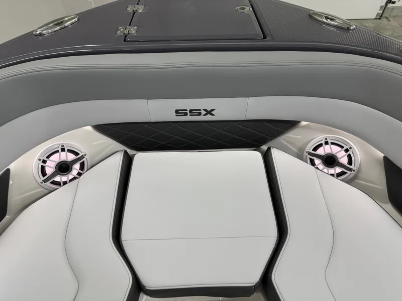 Slide: The Image of 2025 Chaparral 2870 SSX boat interior with gray seating and built-in speakers. - 36