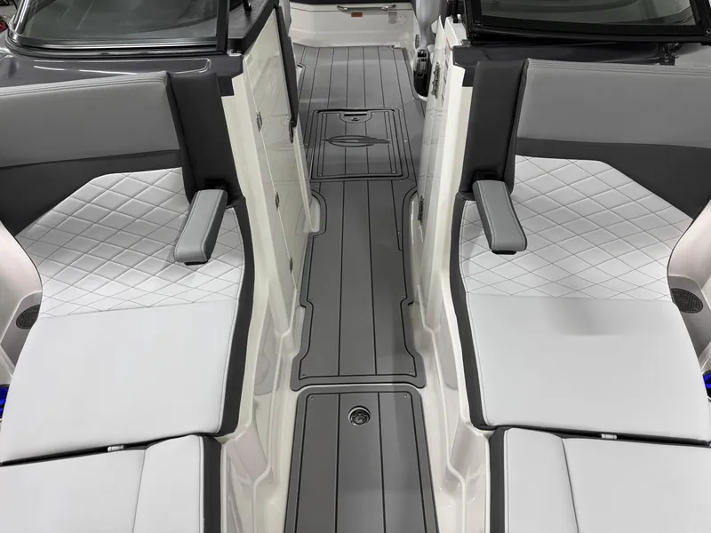 Slide: The Image of 2025 Chaparral 2870 SSX boat interior with gray and white seating and sleek flooring. - 39