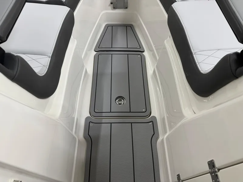 Slide: The Image of 2025 Chaparral 2870 SSX boat interior with sleek seating and storage compartments. - 41