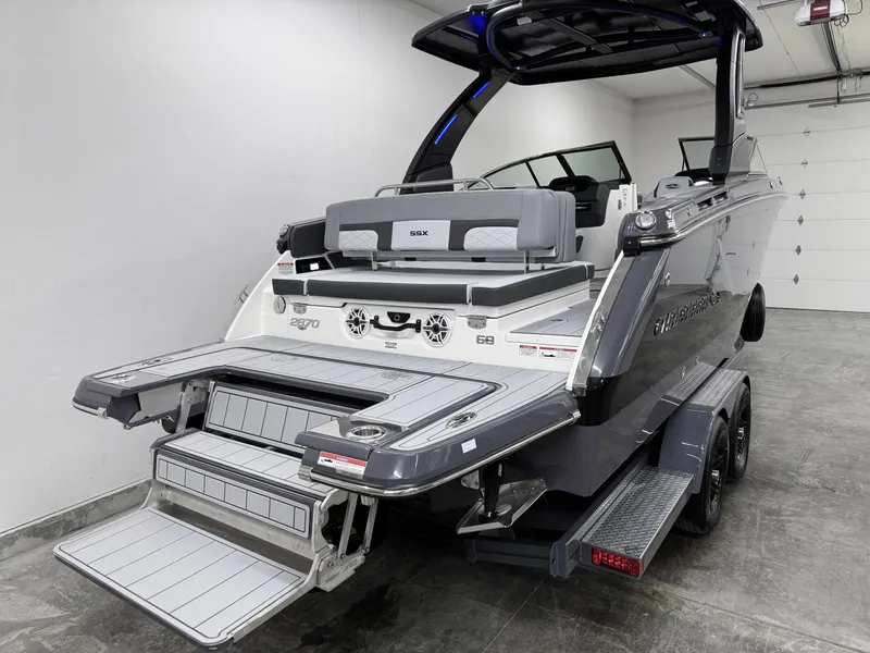 Slide: The Image of 2025 Chaparral 2870 SSX boat in garage, showcasing rear deck and sleek design. - 5