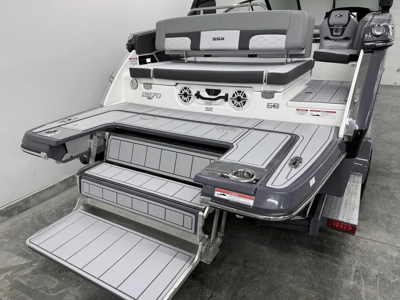 Slide: The Image of 2025 Chaparral 2870 SSX boat with sleek swim platform and seating area. - 6