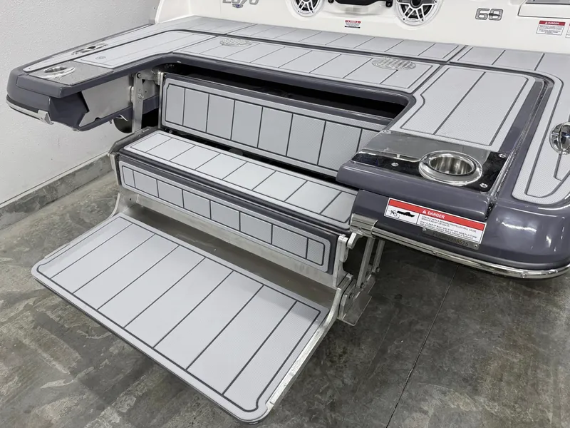 Slide: The Image of 2025 Chaparral 2870 SSX boat swim platform with integrated steps and cup holder. - 7