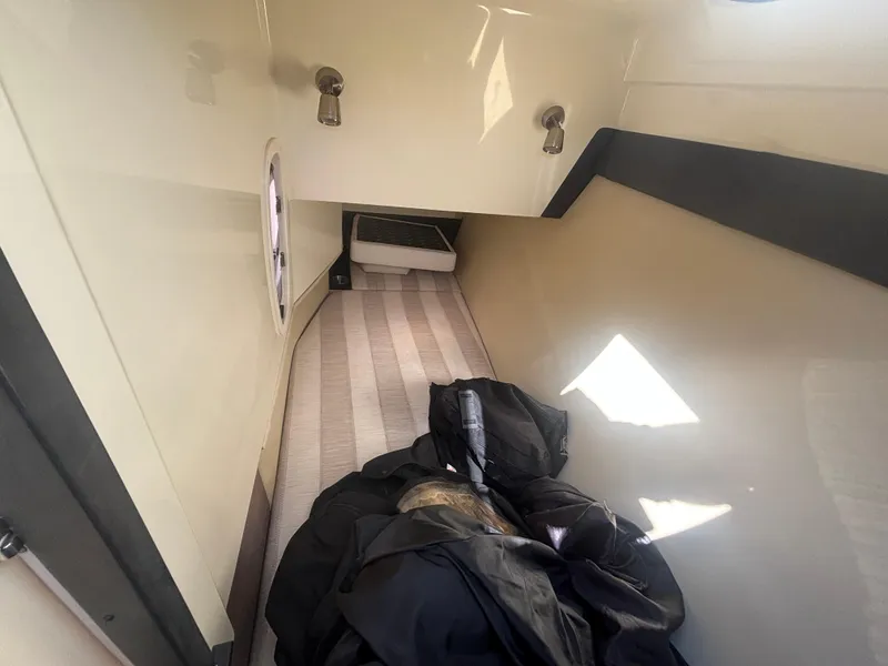 Slide: The Image of 2014 Monterey 328 Super Sport cabin interior with striped flooring and storage area. - 14