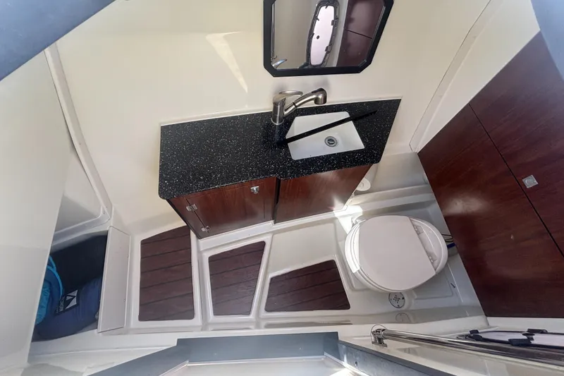 Slide: The Image of 2014 Monterey 328 Super Sport boat bathroom with sink, toilet, and wood accents. - 16