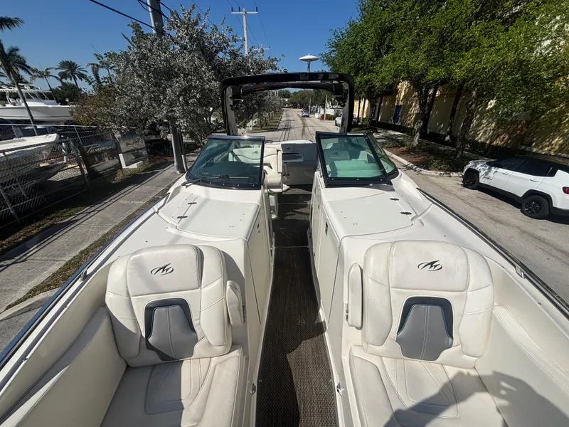 Slide: The Image of 2014 Monterey 328 Super Sport boat with white leather seats and dual windshields. - 19