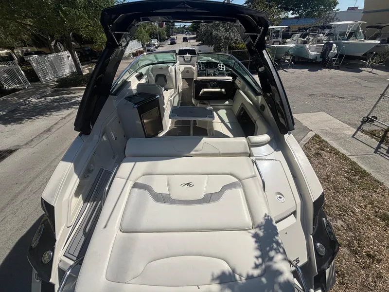 Slide: The Image of 2014 Monterey 328 Super Sport boat with spacious seating and sleek design, parked outdoors. - 8