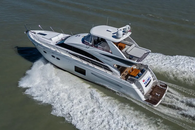 Slide: The Image of 2016 Princess Flybridge 64 Motor Yacht cruising on open water. - 13