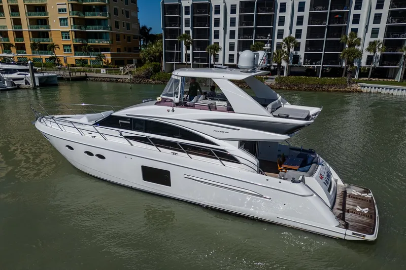 Slide: The Image of 2016 Princess Flybridge 64 Motor Yacht docked near waterfront buildings. - 17
