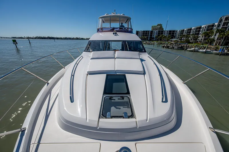 Slide: The Image of 2016 Princess Flybridge 64 Motor Yacht on calm water, showcasing sleek design and luxury features. - 18