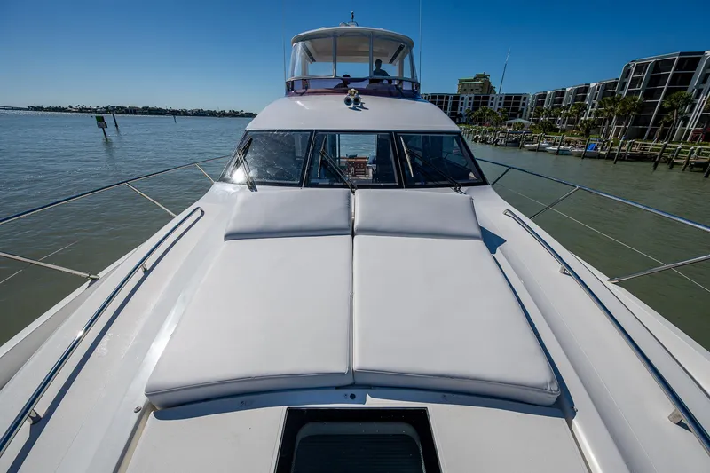 Slide: The Image of 2016 Princess Flybridge 64 Motor Yacht on calm water, featuring spacious deck and sleek design. - 19