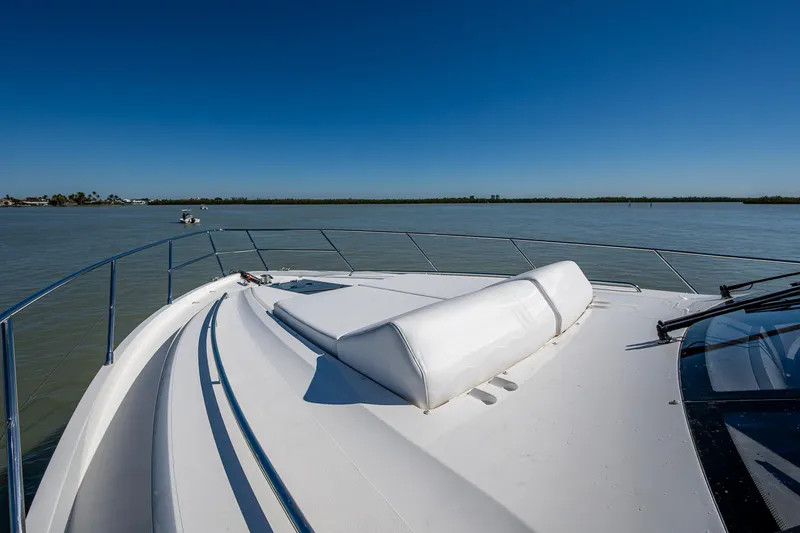Slide: The Image of 2016 Princess Flybridge 64 Motor Yacht on calm water under clear blue sky. - 20