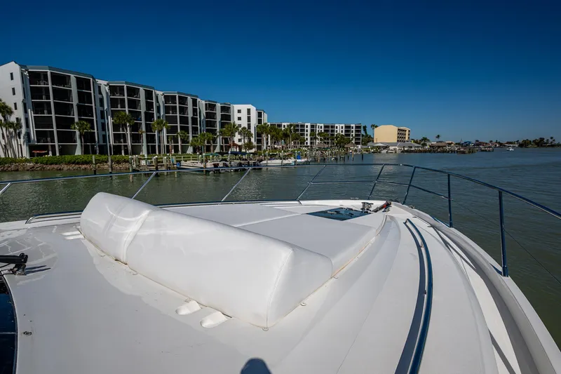 Slide: The Image of 2016 Princess Flybridge 64 Motor Yacht docked near waterfront apartments. - 21