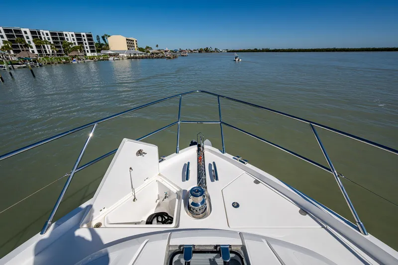 Slide: The Image of Bow view of 2016 Princess Flybridge 64 Motor Yacht on calm waters. - 23