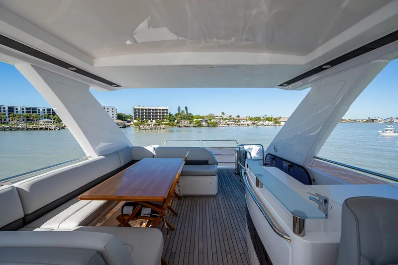 Slide: The Image of Luxurious 2016 Princess Flybridge 64 Motor Yacht with spacious deck and scenic waterfront view. - 30