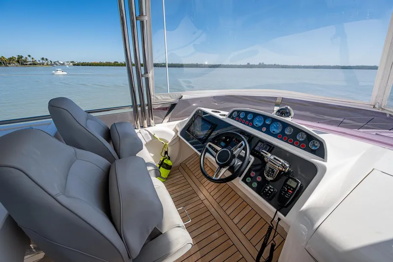 Slide: The Image of Flybridge helm of 2016 Princess Flybridge 64 Motor Yacht with scenic water view. - 34