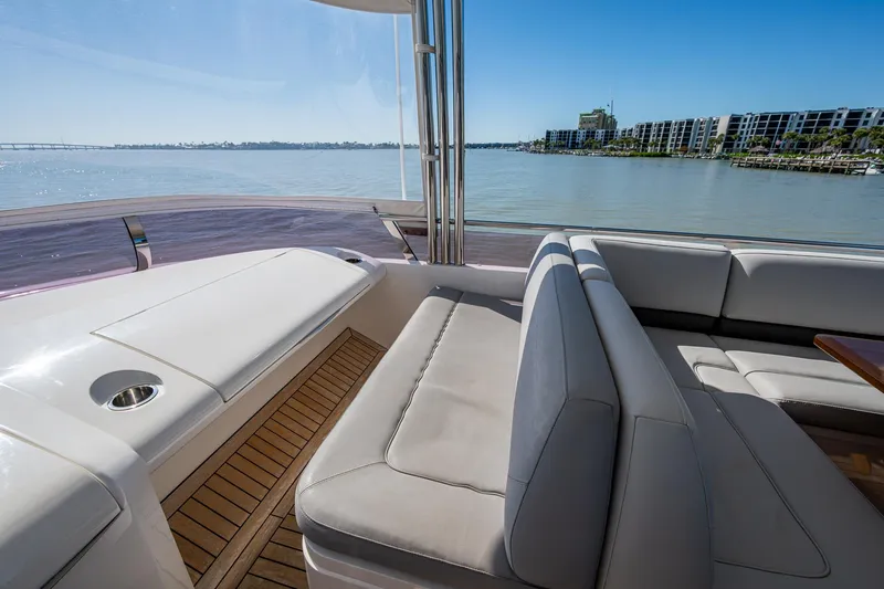 Slide: The Image of Luxurious seating on 2016 Princess Flybridge 64 Motor Yacht with scenic waterfront view. - 35