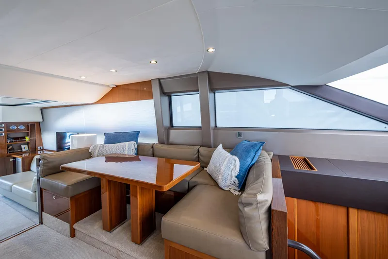 Slide: The Image of Luxurious interior of 2016 Princess Flybridge 64 Motor Yacht with elegant seating and wooden table. - 45