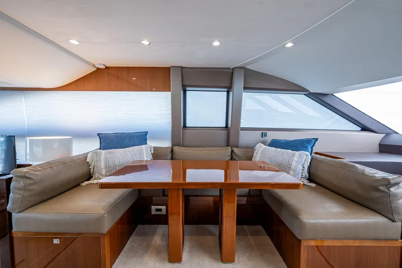 Slide: The Image of Interior of 2016 Princess Flybridge 64 Motor Yacht with elegant seating and wooden table. - 46