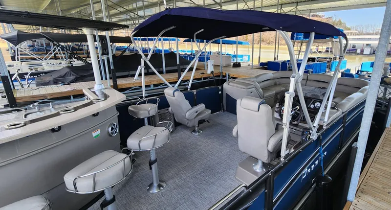 Slide: The Image of 2016 Premier 290 Grand Entertainer pontoon boat with seating and canopy in a marina. - 11