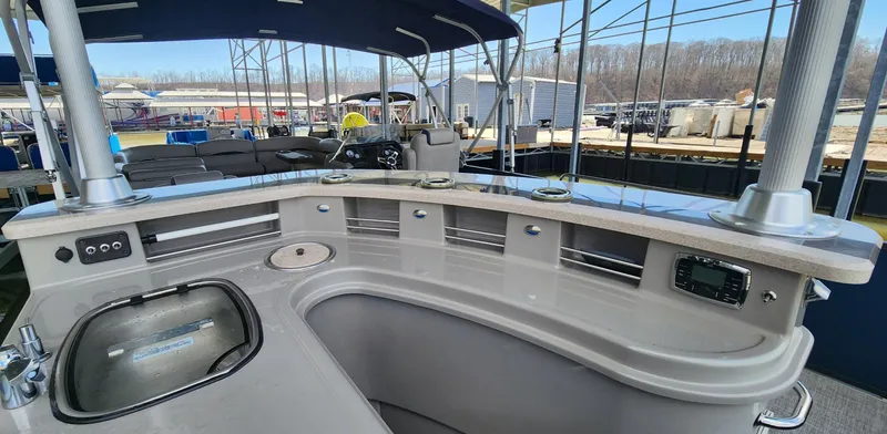 Slide: The Image of 2016 Premier 290 Grand Entertainer boat interior with bar and seating area. - 12