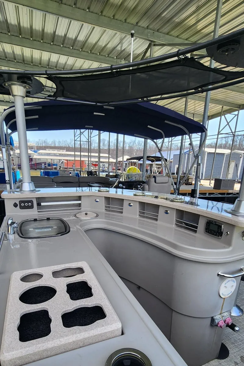 Slide: The Image of 2016 Premier 290 Grand Entertainer boat with covered deck and seating area. - 13