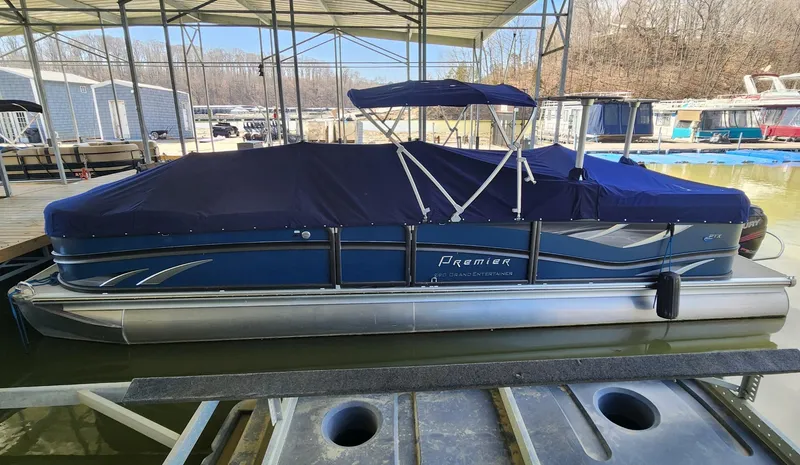 Slide: The Image of 2016 Premier 290 Grand Entertainer pontoon boat docked with blue cover. - 15